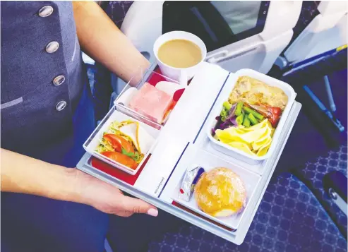  ?? GETTY IMAGES / ISTOCKPHOT­O ?? Flying economy once included multi-course meals served on non-plastic dishes with real metal cutlery, but those days are gone.