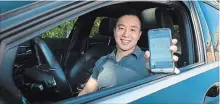  ?? TIJANA MARTIN THE CANADIAN PRESS ?? Justin Lam uses an app that allows his insurance company to monitor his driving.