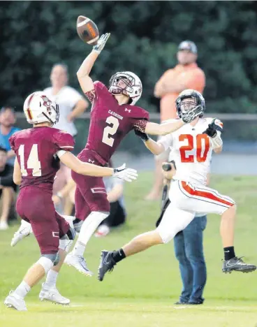  ?? [PHOTO BY SARAH PHIPPS, THE OKLAHOMAN] ?? Cashion’s Sam Brown deflects a pass intended for Crescent’s Jacob Johnson as Cashion’s Austin Vandruff looks on during Friday’s football game. The Cashion Wildcats won, 41-6.