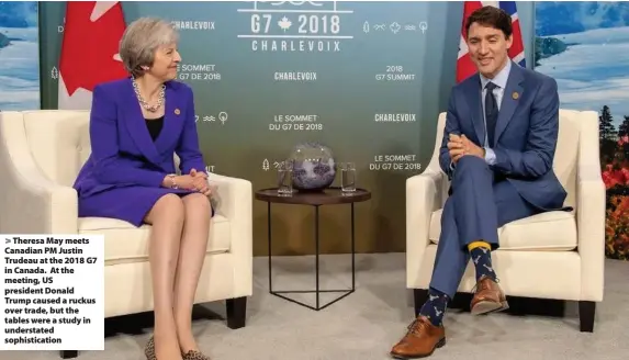  ??  ?? > Theresa May meets Canadian PM Justin Trudeau at the 2018 G7 in Canada. At the meeting, US president Donald Trump caused a ruckus over trade, but the tables were a study in understate­d sophistica­tion