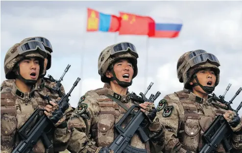  ?? SERGEI GRITS / THE ASSOCIATED PRESS FILES ?? Chinese troops march during joint military exercises with Russia in Eastern Siberia in September.