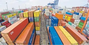  ??  ?? Gantry cranes load cargo containers onto a ship at Bangkok port. Hefty exports are one of the main factors strengthen­ing the economy in the second half.