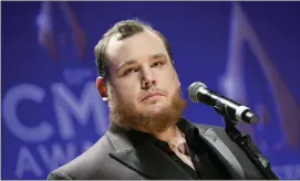  ??  ?? Singer-songwriter Luke Combs speaks in the press room after winning awards for male vocalist of the year and song of the year at the 53rd annual CMA Awards in 2019,