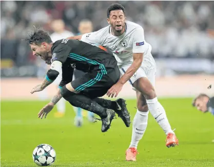  ??  ?? Real Madrid’s Sergio Ramos, left, vies with Tottenham’s Moussa Dembele.