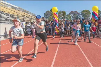  ?? Chris Torres/The Signal ?? Kids take off in a full sprint to start the Michael Hoefflin Foundation ‘Walk for Kids with Cancer” at Cougar Stadium in COC on Saturday.