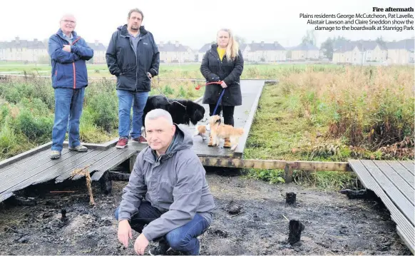  ??  ?? Fire aftermath Plains residents George McCutcheon, Pat Lavelle, Alastair Lawson and Claire Sneddon show the damage to the boardwalk at Stanrigg Park