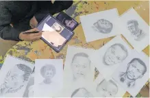  ?? ?? A MEMBER of ‘Art for Memories’ team draws portraits of victims of the Rwandan genocide in Kigali this week. Art for Memories preserves the images of the victims from old photograph­s in portrait drawings to keep the memories alive for the survivors. | AFP