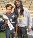  ?? COURTESY OF CJ MONTES ?? CJ Montes holds a youth national championsh­ip trophy and poses with his coach, Snoop Dogg, in December 2016.