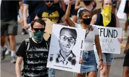  ?? ?? An image of Elijah McClain during a rally in Aurora, Colorado, in 2020. Photograph: David Zalubowski/AP