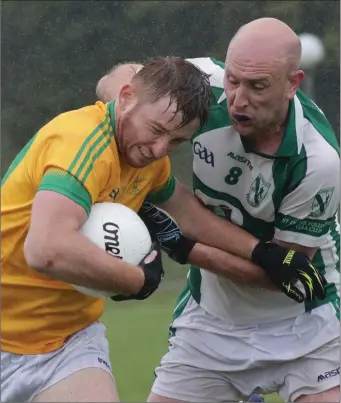  ??  ?? Emmet Kent of Clongeen is tackled by Stephen Burke (Volunteers) in their Group B encounter.