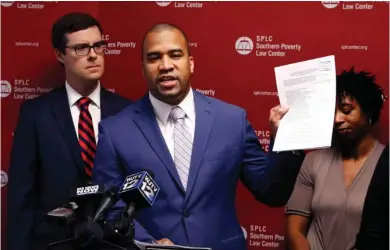  ?? (Photo by Rogelio V. Solis, AP) ?? Jody Owens, director of the Mississipp­i office of the Southern Poverty Law Center, holds up a copy of a lawsuit filed on behalf of four African-American mothers with children in public elementary schools during a news conference in Jackson, Miss.,...