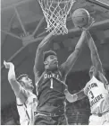  ??  ?? Duke center Vernon Carey Jr., middle, shoots against Boston College guard Jared Hamilton, right, Tuesday in Chestnut Hill, Mass.