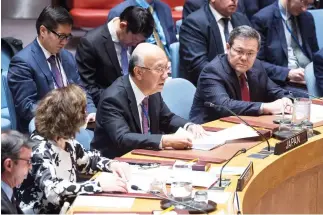  ??  ?? Koro Bessho, center, Japan’s permanent representa­tive to the UN, presents a draft resolution on the situation in the Middle East, at the Security Council on Friday. Russia again vetoed a UN resolution that would extend the mandate of the expert body...