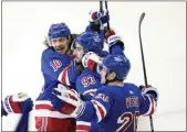  ?? FRANK FRANKLIN II — THE ASSOCIATED PRESS ?? Mika Zibanejad (93) celebrates with Rangers teammates after scoring what proved to be the winning goal.