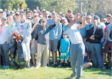  ?? DONALD MIRALLE/GETTY IMAGES ?? Tiger Woods plays his 2nd shot from the rough on the 11th hole during the 1st round of the Farmers Insurance Open at Torrey Pines on Thursday. It would be the last hole he played before withdrawin­g from the tournament.