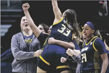  ?? WADE PAYNE/AP ?? TOLEDO GUARD YANIAH CURRY (24), guard Sammi Mikonowicz (33), and guard Justina King (1) celebrate after a first-round game against Iowa State in the NCAA Tournament on Saturday in Knoxville, Tenn.