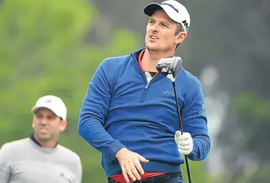  ?? Getty Images. ?? Sergio Garcia watches Ryder Cup team-mate Justin Rose drive off at the ninth hole.