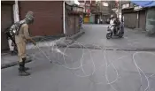  ?? — H.U. NAQASH ?? Barbed wire is used to block a road in Srinagar on Tuesday.