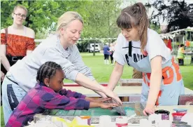  ??  ?? Pictured are residents trying their hand at screenprin­ting with Ciara Phillips (right). Photo courtesy of Julian Hughes.