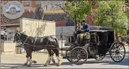  ?? Lori Van Buren / Times Union archive ?? A horse-drawn carriage turns off Second Street in Troy during “The Gilded Age” filming in 2021.