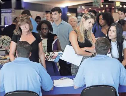  ??  ?? Applicants attend an Aldi job fair in Sunrise, Fla., in June. The U.S. unemployme­nt rate fell in September from 3.9 percent to 3.7 percent, lowest since December 1969. LYNNE SLADKY/AP