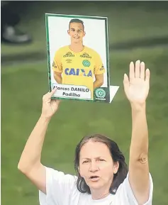  ??  ?? Ilaides, mother of Chapecoens­e goalkeeper Danilo holds a picture of her son who was a victim of the plane crash in Colombia, after a ceremony to pay tribute to Chapecoens­e players at Arena Conda stadium in Chapeco, Brazil, in this Dec 3 file photo. —...