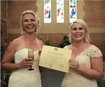  ?? PHOTO: DAN HIMBRECHTS/AAP ?? ABSOLUTELY DELIGHTED: Sarah Turnbull and Rebecca Hickson share their joy after marrying in Newcastle yesterday morning.