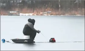  ?? (Erie Times-NewsJack Hanrahan) ?? Rob Votaw of Waterford Township fishes through the ice on Lake Pleasant in Venango Township, Pa.