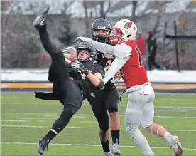  ?? JOHN RENNISON THE HAMILTON SPECTATOR ?? St. Thomas More’s Ethan Monaghan intercepts a ball intended for Cardinal Newman’s Ryan Ogilvie in the GHAC final at St. Thomas More on Tuesday. St. Thomas More won 20-9.