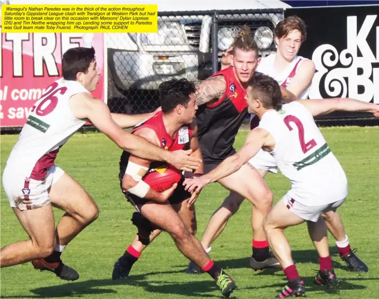  ??  ?? Warragul’s Nathan Paredes was in the thick of the action throughout Saturday’s Gippsland League clash with Traralgon at Western Park but had little room to break clear on this occasion with Maroons’ Dylan Loprese (26) and Tim Northe wrapping him up....