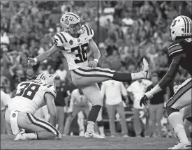  ?? BUTCH DILL/AP PHOTO ?? LSU place kicker Cole Tracy (36) kicks the winning field as time expires to give the No. 12 Tigers a 22-21 win over No. 7 Auburn on Saturday in Auburn, Ala.