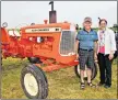  ?? DESIREE ANSTEY/ JOURNAL PIONEER ?? Peter Roberts, farm co-owner and event organizer, and Beth Corney Gauthier, director of The Children’s Wish Foundation, P.E.I. chapter stand in front of a 1965 Allis Chalmers tractor on display at the Antique Farm Show in Kinkora.