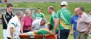  ??  ?? Duffry Rovers defender Donie Doyle receives treatment after his unfortunat­e injury.