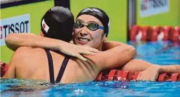  ?? AFP PIC ?? Japan’s Rikako Ikee (right) is congratula­ted by teammate Tomomi Aoki after winning the Asian Games 100m freestyle final yesterday.