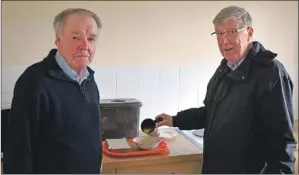  ??  ?? Ian Fleming, Scarinish, receives the first of the Cùram Meals on Wheels with volunteer driver Reverend Alan Millar.