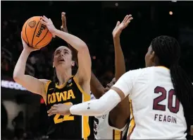  ?? AP PHOTO/MORRY GASH ?? Iowa guard Caitlin Clark (22) shoots over South Carolina forward Sania Feagin (20) during the second half of the Final Four college basketball championsh­ip game in the women’s NCAA Tournament, Sunday, April 7, 2024, in Cleveland.
