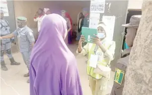  ?? ?? INEC official taking picture of a voter at K/Adamu polling unit 032 Majidadi Ward in Bauchi metropolis. Photo: Hassan Ibrahim