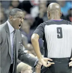  ?? CHUCK BURTON/AP ?? Raptors coach Dwane Casey, left, argues a call during Toronto’s win over the Charlotte Hornets on Wednesday.