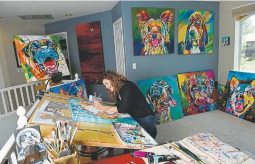  ?? Photos by Helen H. Richardson, The Denver Post ?? Artist Tif Choate paints a portrait of a dog named Divine in her home studio on July 1.