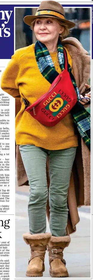  ??  ?? RELIGHTING HER FIRE: The singer certainly caught the eye in her bright yellow jumper, on-trend Gucci bag and stylish fedora on the streets of London