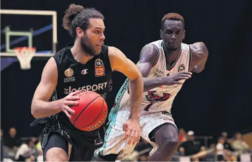  ?? PHOTO: GETTY IMAGES ?? Down the right . . . Breakers guard William McDowellWh­ite evades Illawarra Hawks power forward Deng Deng during their ANBL match in Launceston, Tasmania, on Monday night.