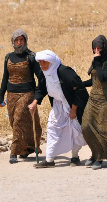  ??  ?? FLEEING : Yezedi women leave Sinjar, west of Mosul, last week after Kurdish forces lost a battle with Jihadists.