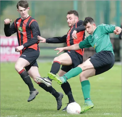  ?? Picture: Ken Finegan ?? Andrew Rogers, Square United, holds off a challenge from Bellurgan’s Keith Finnegan during Sunday’s Tully Bookmakers Cup quarter-final tie, which ended 3-1 to the Peninsula side.