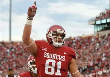  ?? File, Sue Ogrocki / AP ?? Oklahoma tight end Mark Andrews (81) celebrates a touchdown in the second quarter of a game against West Virginia, Andrews and teammates Baker Mayfield and Orlando Brown were selected to the AP All-America team.