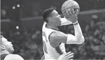  ?? [AP PHOTO] ?? Oklahoma City Thunder guard Russell Westbrook, right, shoots as Los Angeles Clippers forward Blake Griffin defends during Thursday’s game in Los Angeles.