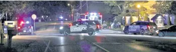  ?? GREG FURMINGER / POSTMEDIA NETWORK FILE PHOTO ?? Police and emergency crews at the scene of a triple-shooting in Fenwick in October 2015.