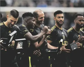  ?? AP PHOTO/JAE C. HONG ?? Los Angeles FC players stand on the field with their 2022 MLS Championsh­ip rings before the team’s soccer match against the Portland Timbers on Saturday in Los Angeles.