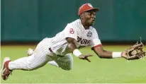  ?? JOHN PETERSON/AP ?? Oklahoma left fielder Kendall Pettis makes a diving catch against Mississipp­i in the ninth inning Saturday night at the College World Series in Omaha, Nebraska.