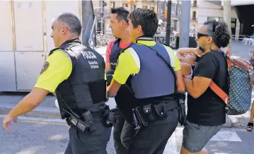  ?? ORIOL DURAN/THE ASSOCIATED PRESS ?? A woman is carried Thursday in Barcelona, Spain, after a white van jumped the sidewalk in the historic Las Ramblas district, crashing into a summer crowd of residents and tourists, killing more than a dozen people and injuring scores of others.