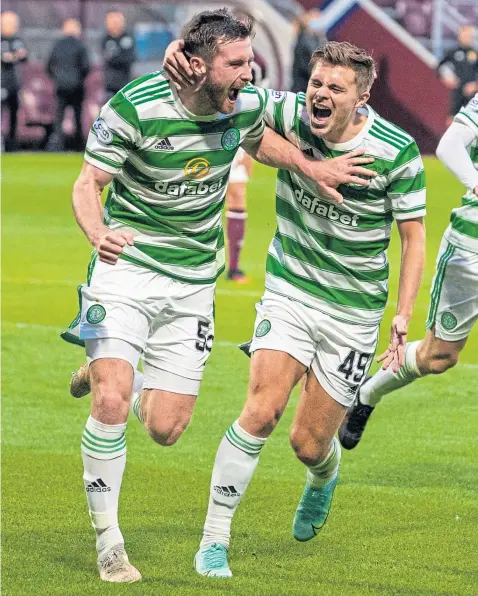  ??  ?? Anthony Ralston celebrates his terrific equaliser at Tynecastle with James Forrest